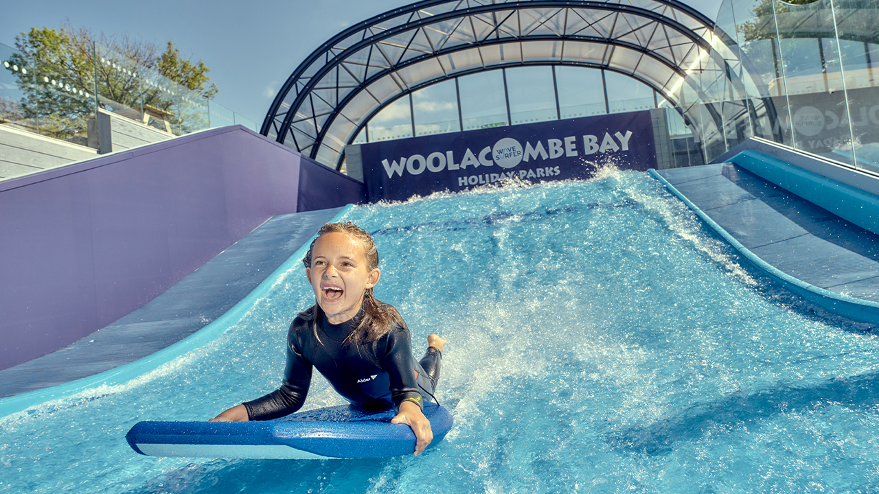 picture of a young girl riding a Wavesurfer surfing simulator at Twitchen House Holiday Park