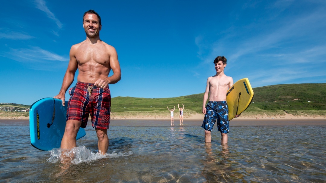 Father and son on Woolacombe Sands beach