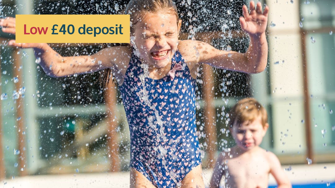 Girl and boy on Splashpad at Twitchen House Holiday Park